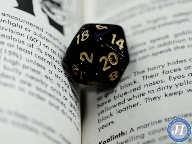 Gaming dice & book for Storytelling through Dungeons and Dragons course at Athena's Advanced Academy